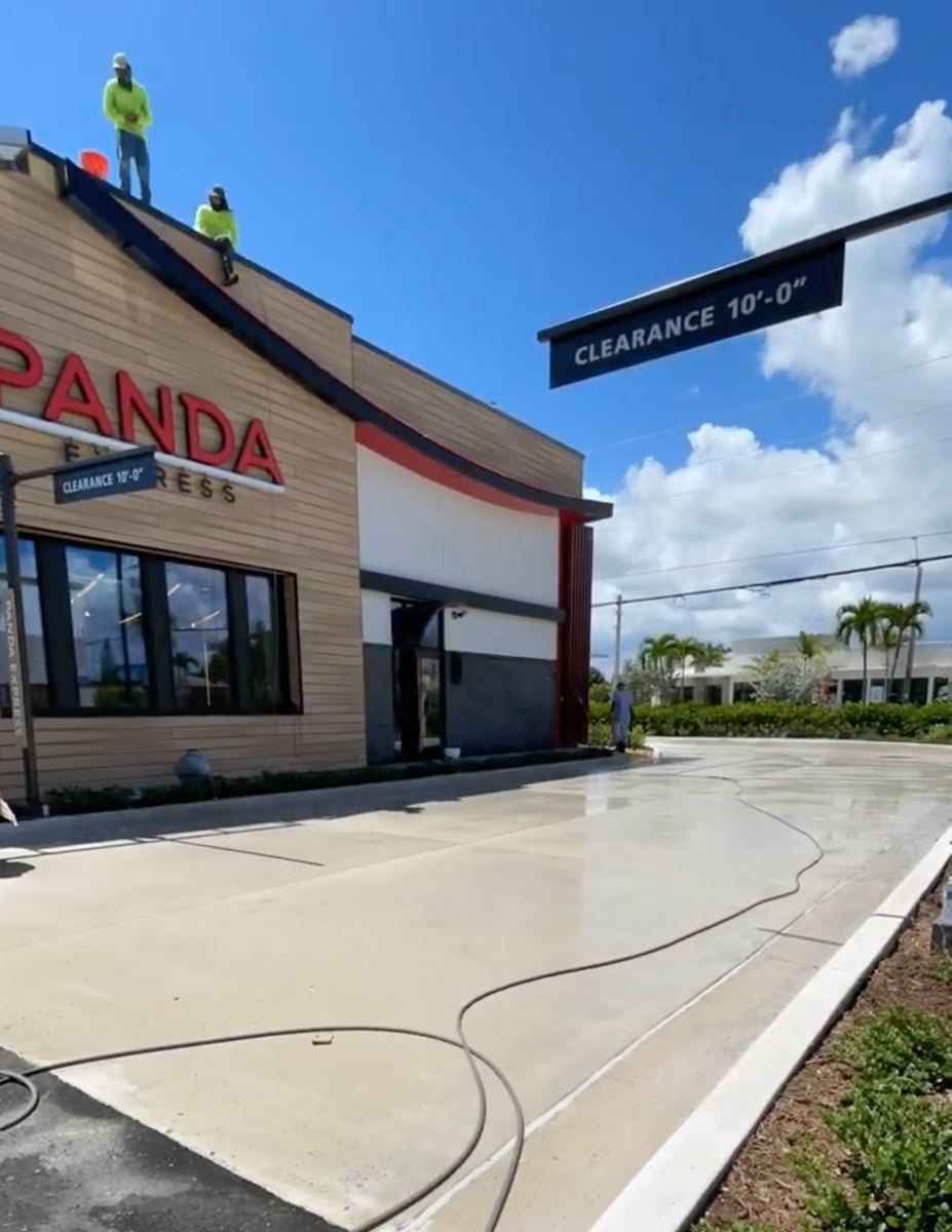 Wide shot of commercial pressure washing services at a Panda Express drive-thru in South Florida