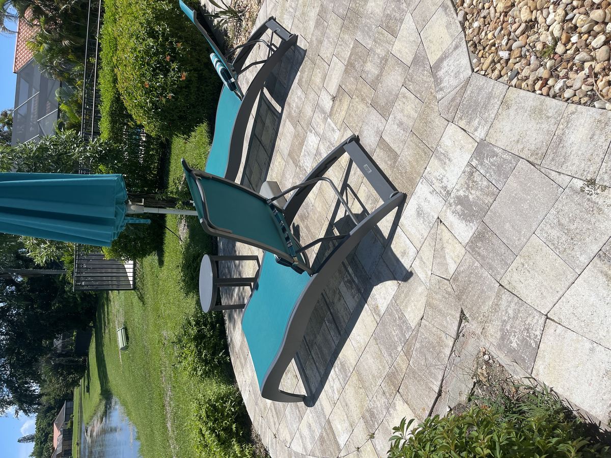 Stained paver pool deck patio in Boca Raton needing professional cleaning
