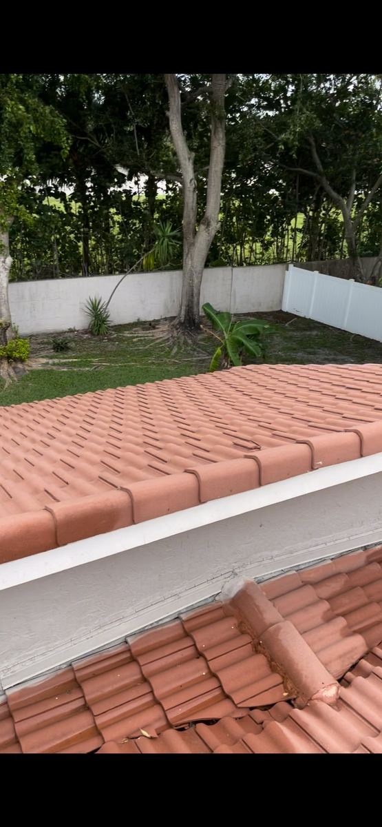 Clean terra cotta tile roof restored to original color after professional soft-wash in South Florida